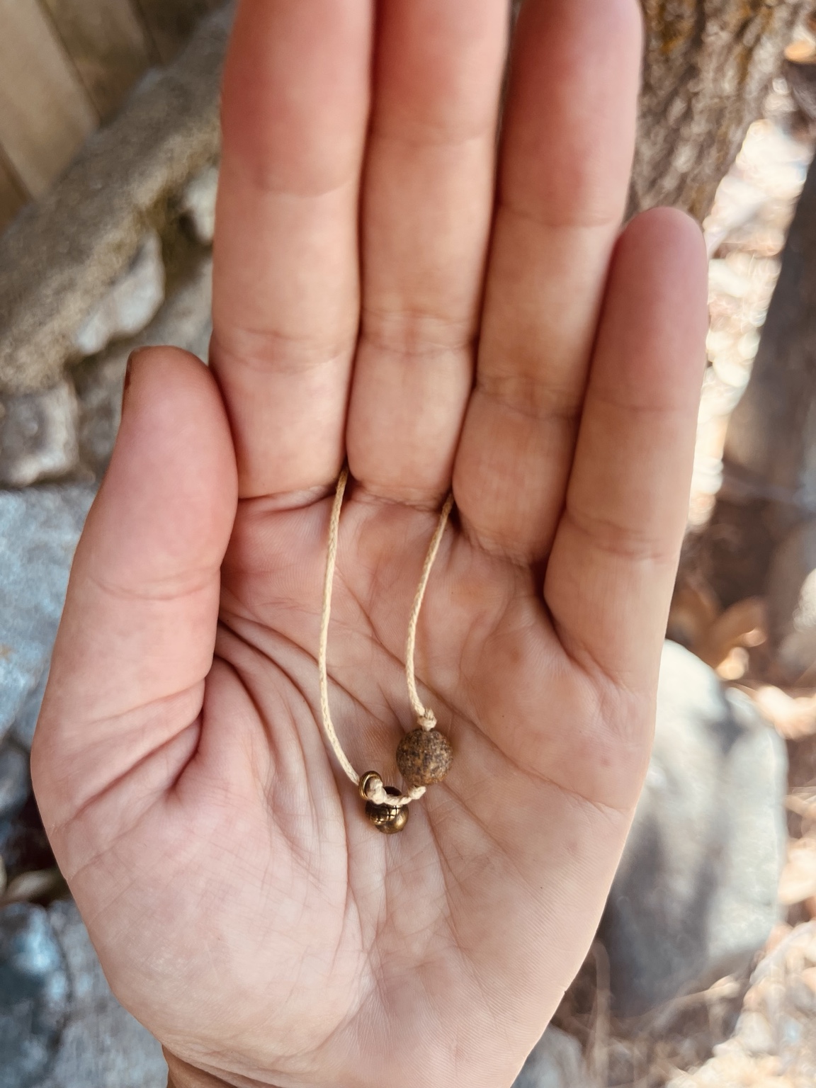 A handmade Rising Oak keepsake resting in an open palm